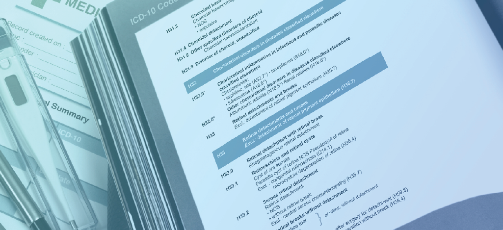  Avoiding medical upcoding and downcoding - ICD-10 code book on a doctor’s table with other medical forms.