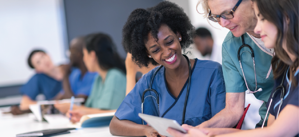 Avoiding upcoding and downcoding - Female doctor training her medical staff about proper medical coding.