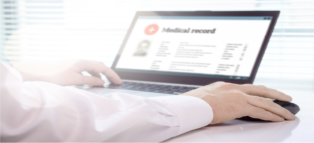 Doctor accessing patients’ medical records and billing using a laptop.