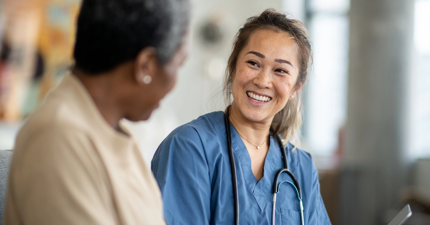 A concept of building patient loyalty - Female doctor speaking with her patient in a healthcare facility.