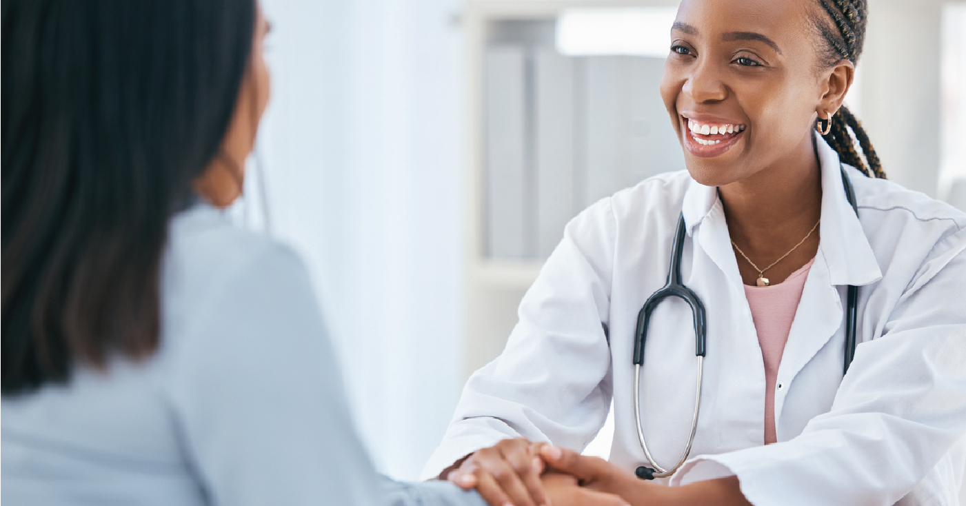 Solving patient leakage issues - Female doctor holding the hand of her female patient during a consultation.