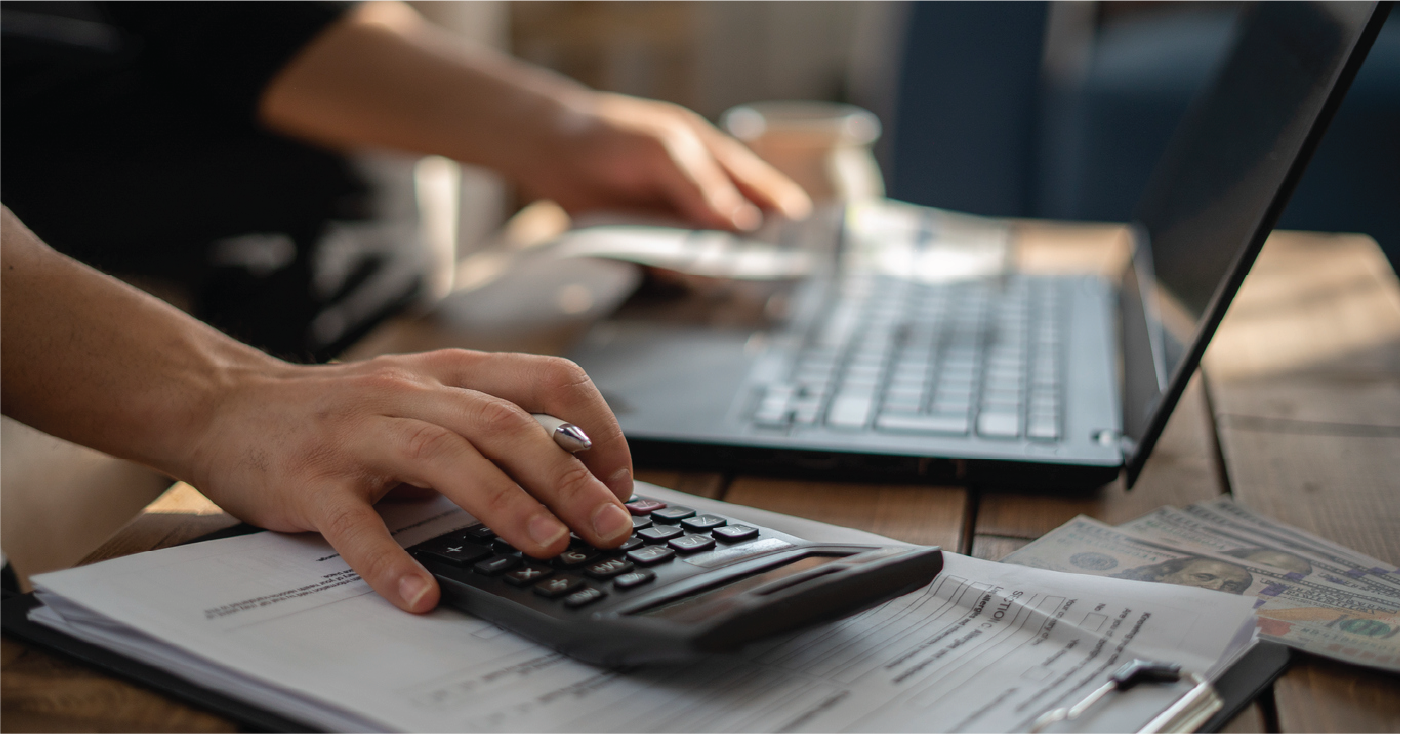 Woman using a laptop and calculator to pay medical bills online - payment processing system concept.