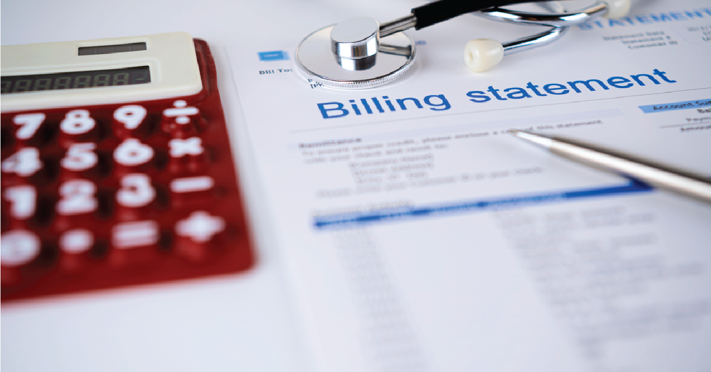 Medical patient statements on a table with a doctor’s stethoscope, a pen, and a calculator.