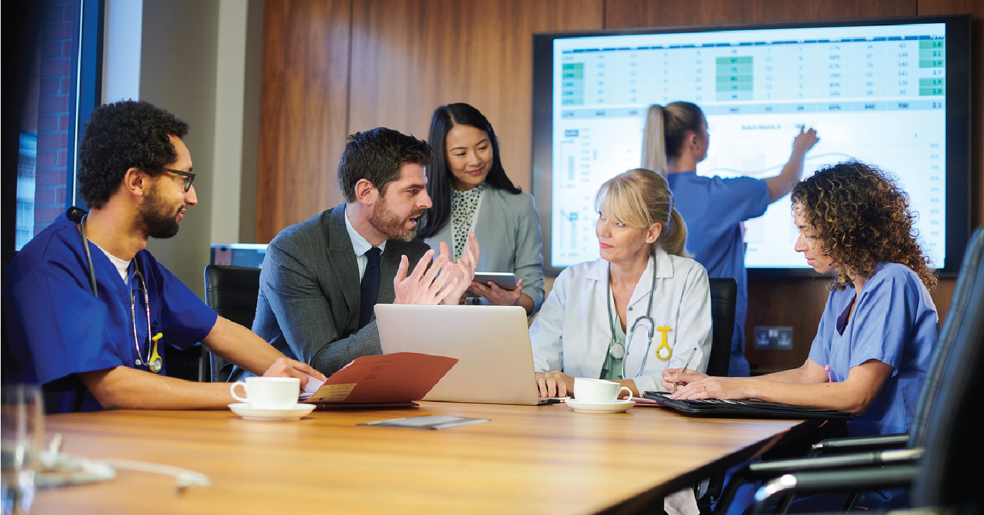 Group of doctors in a meeting using revenue cycle management analytics to check for organizational issues.