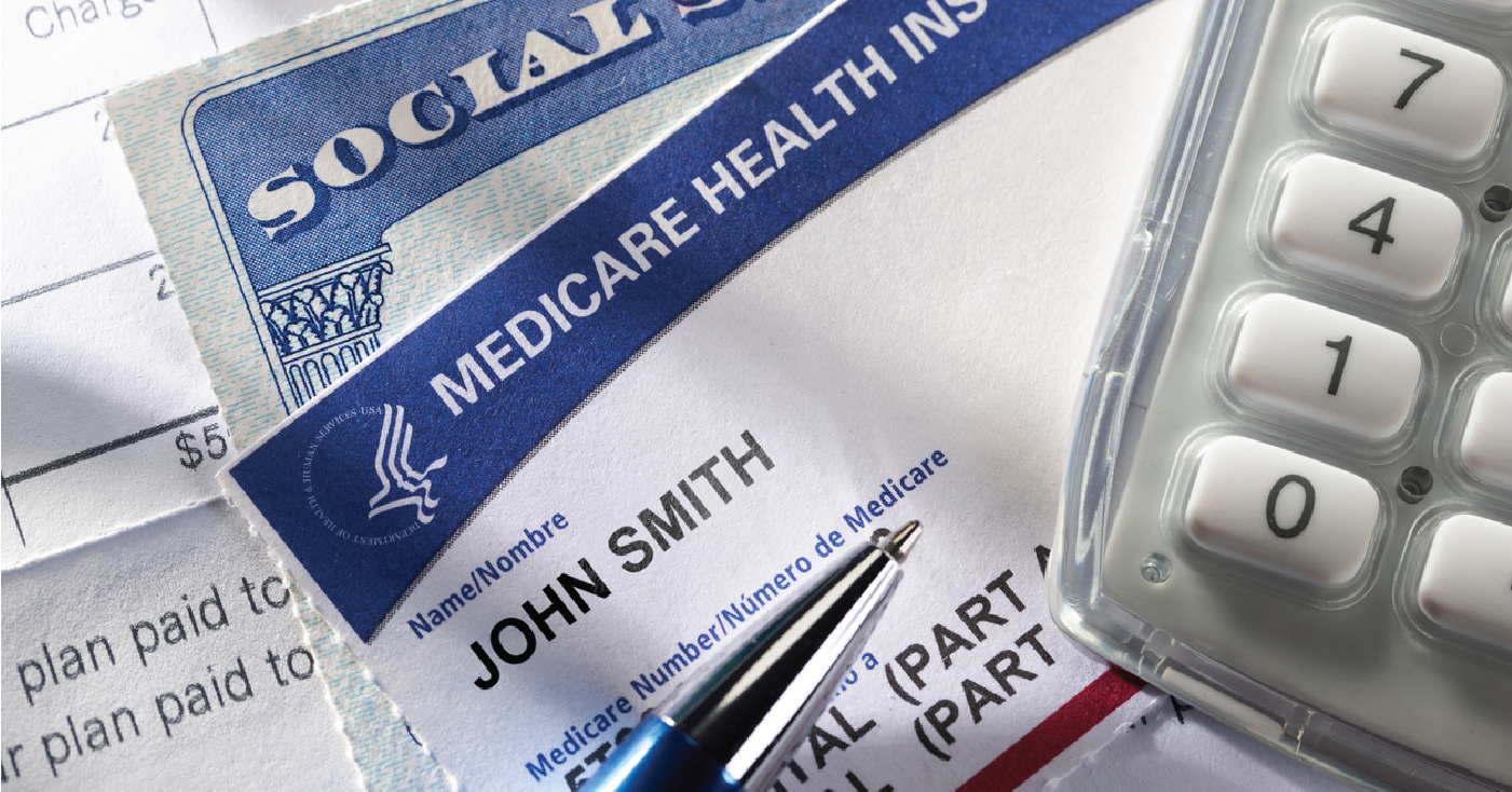 Navigating Medicare changes - Medicare health insurance forms and bills on top of a table with a pen and calculator.