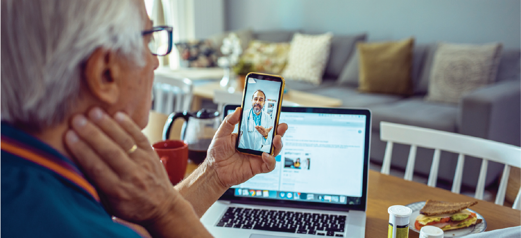 Preventing patient leakage - Male doctor having a telehealth consultation with a senior patient.