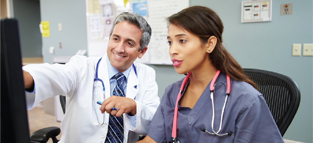 Ensuring effective clean claims submission - Male doctor training his female medical staff.