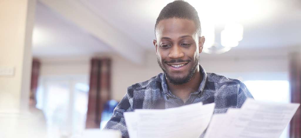 Increasing patient engagement through reliable patient statements - A man checking his medical statement at home.