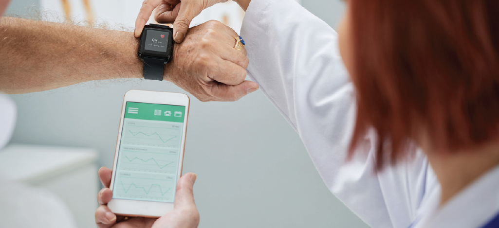 Enhancing patient engagement - Doctor setting up a wearable device for her senior patient.