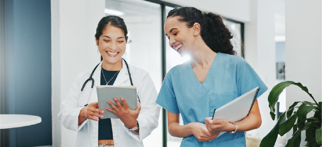 Two medical professionals reviewing patient data using an EMR system.