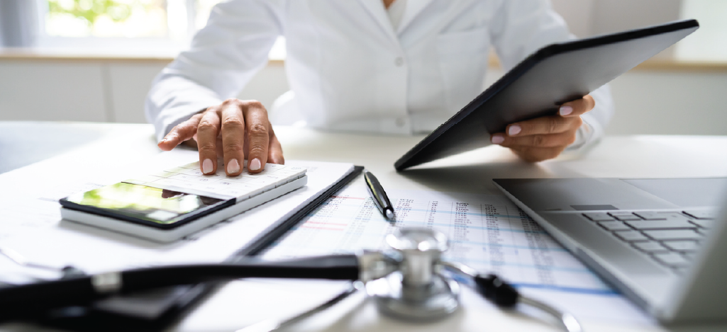 Relative value units - Female doctor holding a digital table while computing patient bills.