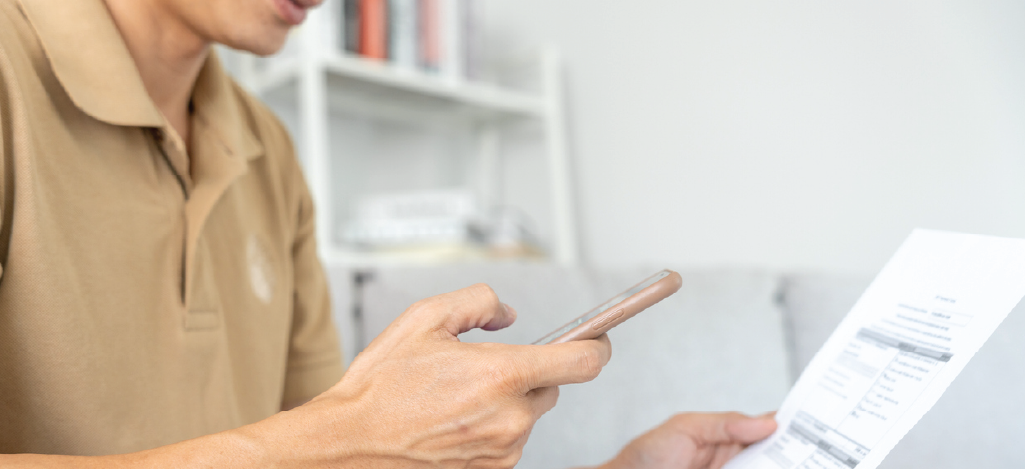  QR codes on patient statements - A man scanning a QR code using his smartphone.