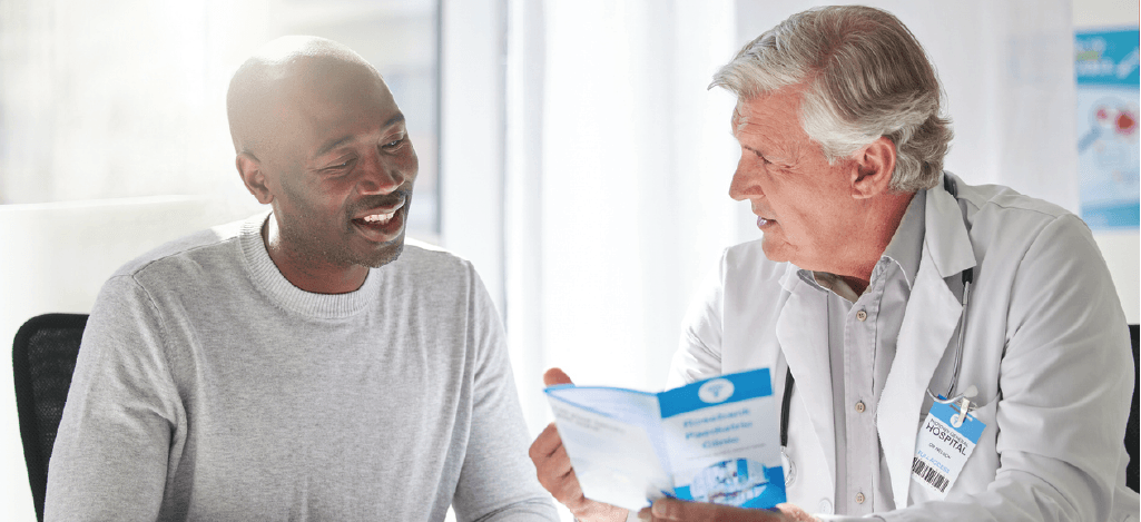 Male doctor explaining patient payment plans to his male patient.