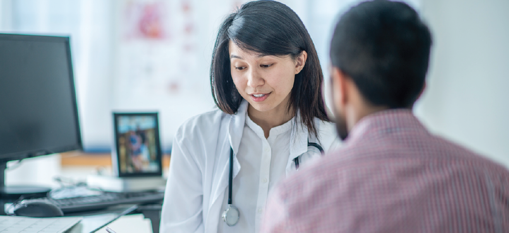 Using technology for revenue integration - Female doctor using a digital tablet during a patient consultation.