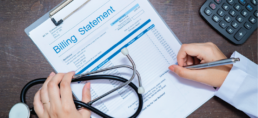 A female doctor holding a stethoscope while signing patient statements.