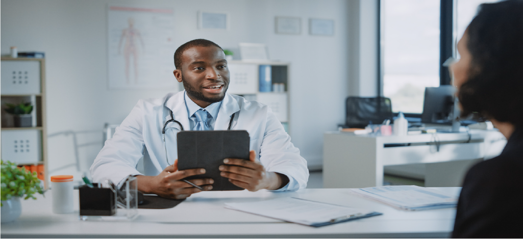 Integrating revenue cycle management - Male doctor explaining payment procedures to a patient during a consultation.
