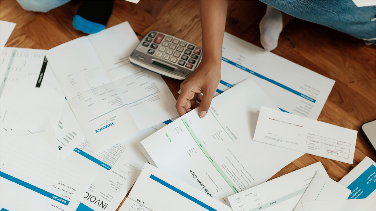 Person looking at a pile of invoices showcasing how important medical debt rules are