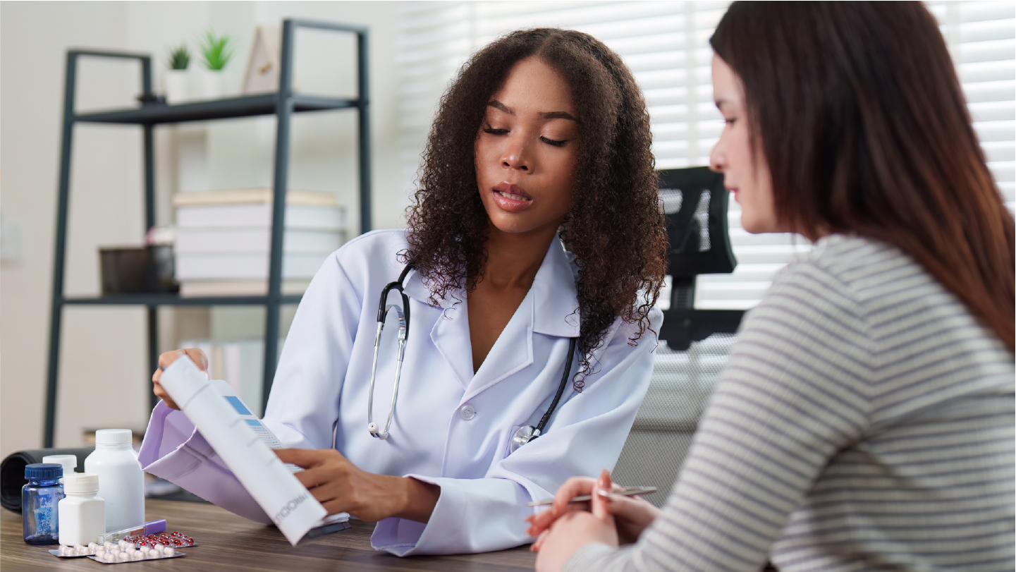 Doctor talking to patient about patient costs for the visit