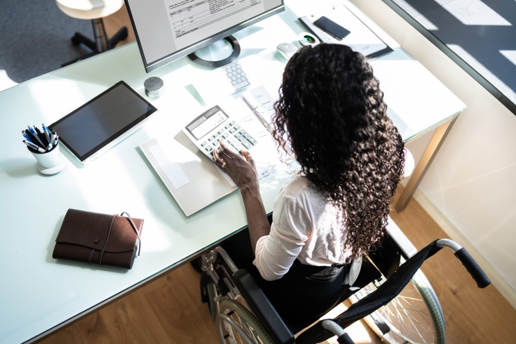 A female accountant utilizing the revenue cycle management system for invoicing.