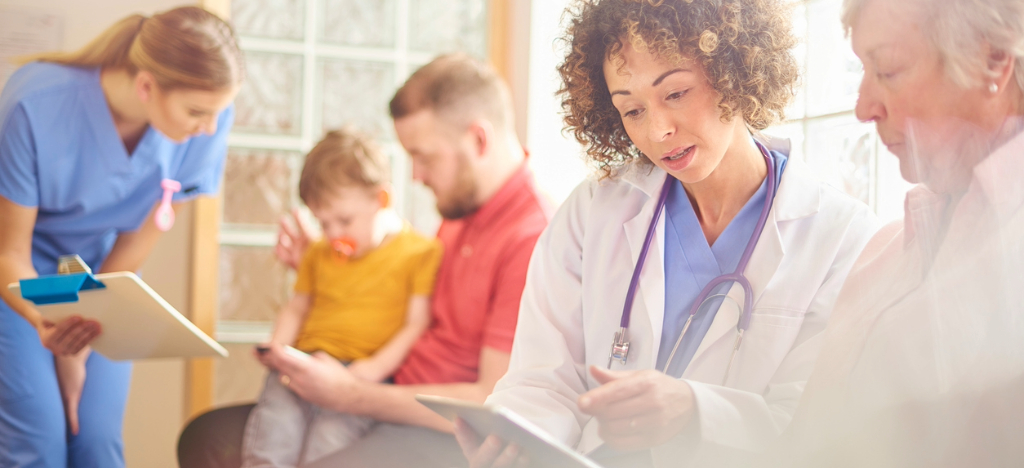 Improving billing strategies - Two female hospital staff members assisting patients in the lobby.