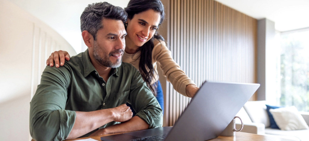 Medical billing software for small practices - A couple at home looking at their medical bill using a laptop.