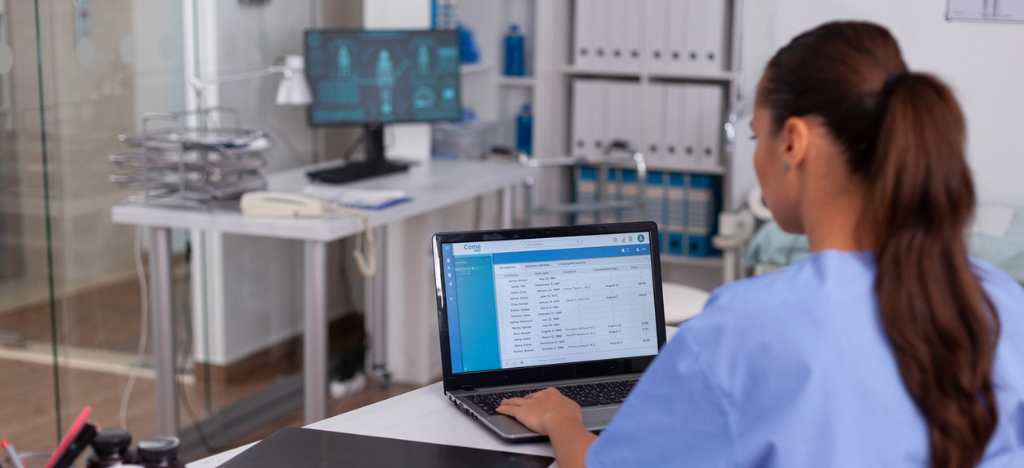 Billing software for medical practices - A female medical staff member using a laptop to access billing software.