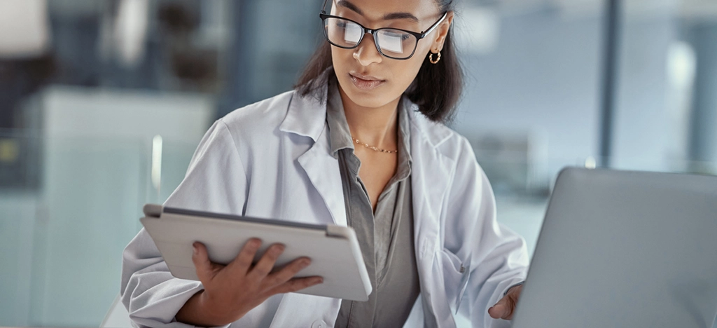 Shot of a young female doctor using a digital tablet at work.