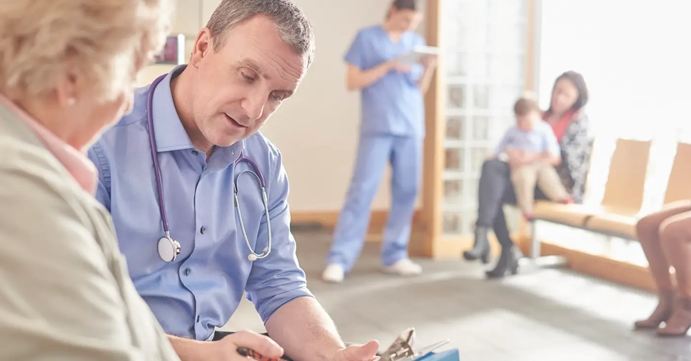 Doctor explaining medical charges to a female patient - enhancing patient billing experience.