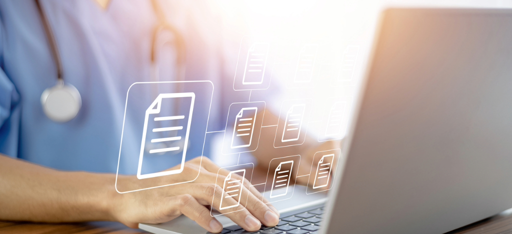 Billing software for medical practices - A doctor using a laptop to manage patient data.