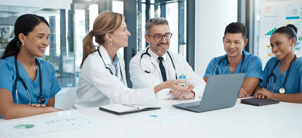 Outsourcing revenue cycle management - A team of hospital professionals discussing their practice’s revenue.