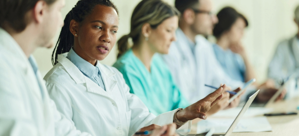 Fixing the billing experience - A group of doctors discussing their practice’s revenue.