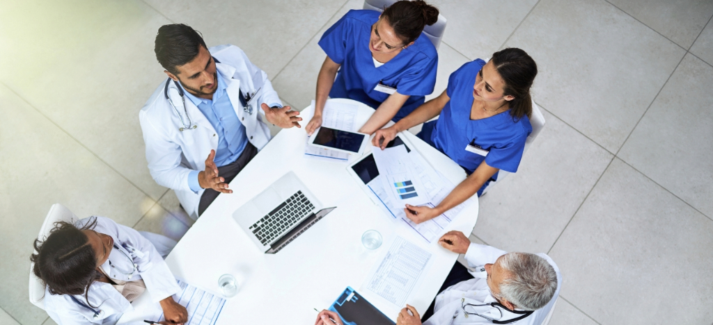 Price transparency in healthcare - A team of medical professionals discussing hospital operations during a meeting.