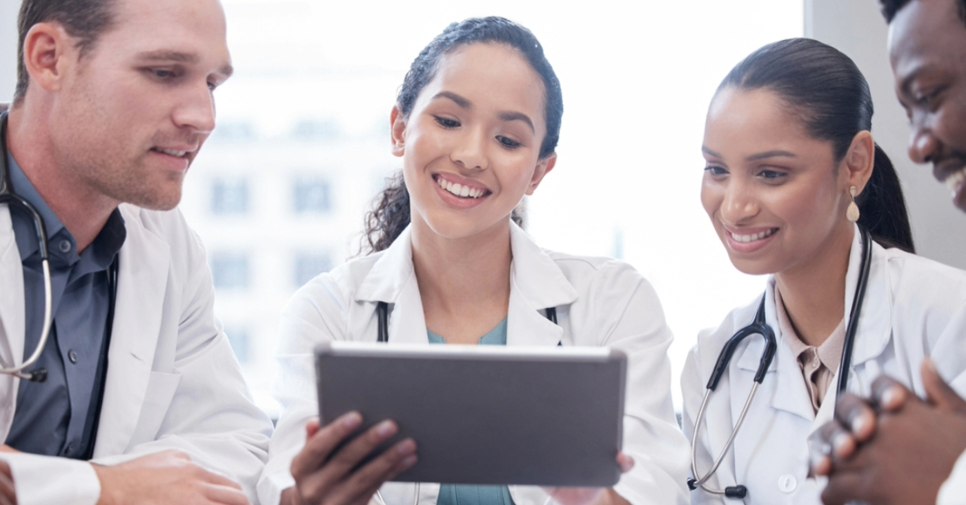 Fixing the billing experience - A group of doctors using a tablet device to access their practice’s medical billing software.
