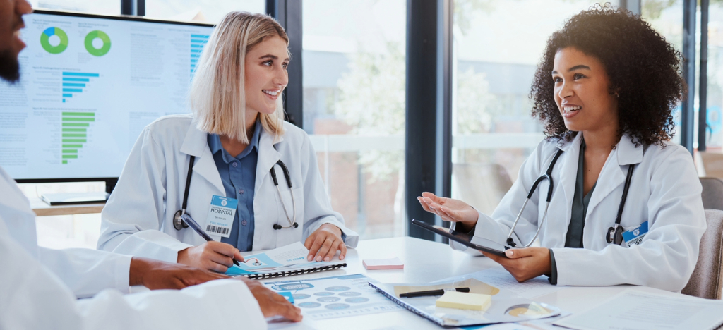 A team of doctors discussing hospital revenue during a meeting.