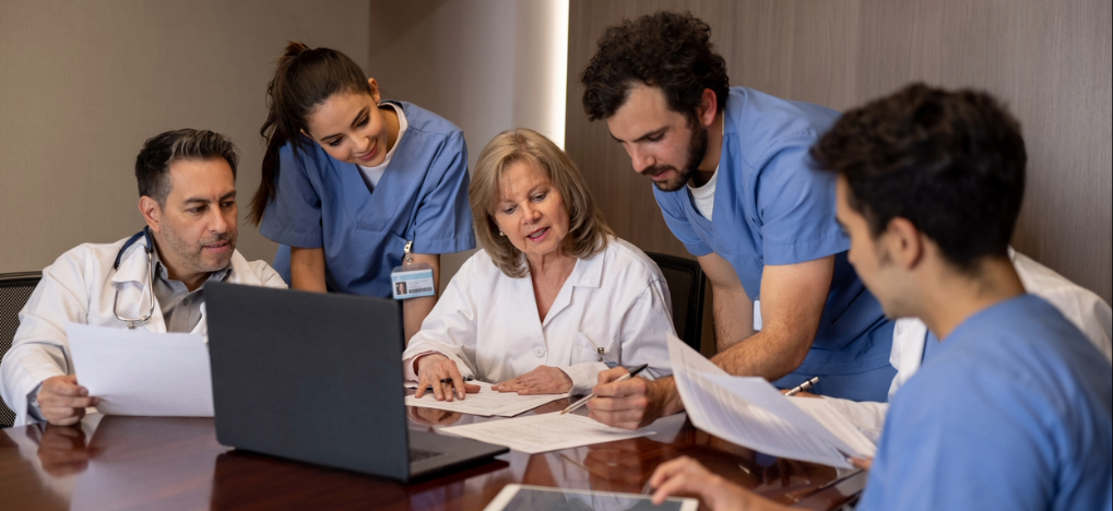 Outsourcing revenue cycle management - A team of medical professionals reviewing their organization’s revenue cycle.