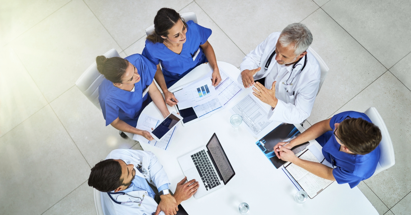 Medical debt collection - A team of medical professionals in a meeting discussing medical debt management.