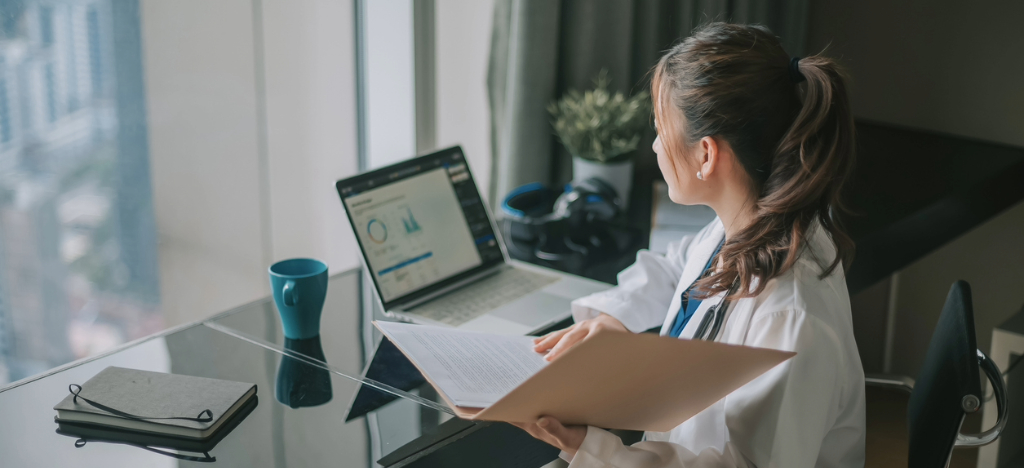 Payment strategies - A female doctor using her laptop to view her practice’s revenue analytics.
