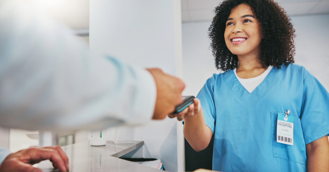 Patient payment plan - A female hospital staff member assisting a patient paying his medical bills using a credit card.