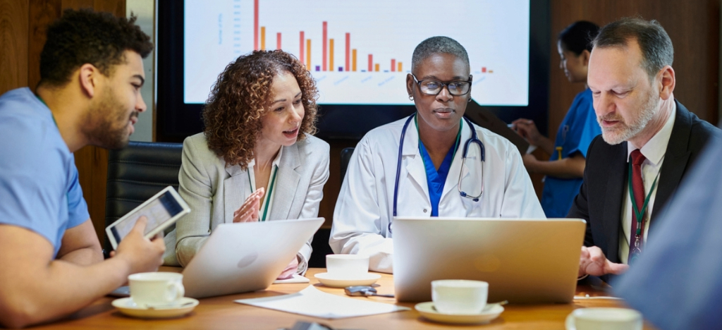 Outsourcing medical billing - A team of doctors and medical billing vendors discussing practice billing solutions.