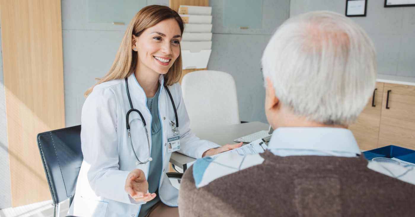 Payment barriers in infusion centers - A female doctor explaining treatment procedures and costs to her senior male patient.