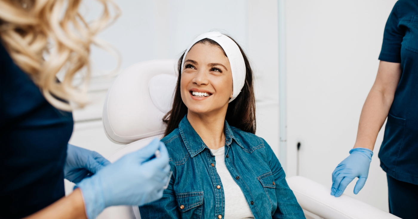 Plastic surgery clinics - A young woman talking to her doctors before undergoing a plastic surgery procedure.