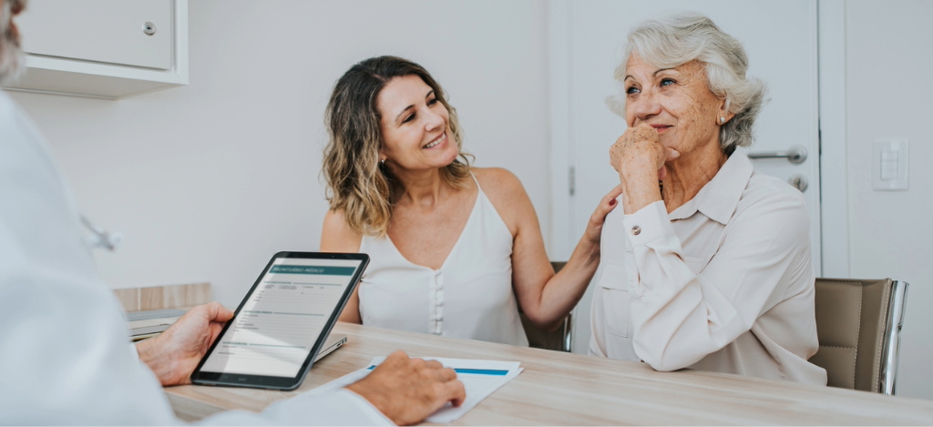 Deductible reset - A senior woman accompanied by her daughter during her medical appointment.