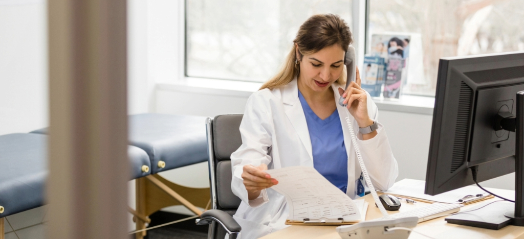 Medical billing software for small practices - A female doctor calling a patient regarding their medical bill.