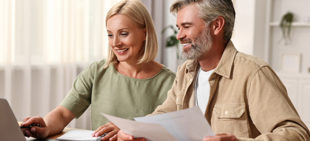 Simplifying medical office payments - A couple at home using a laptop to pay their medical bills online.