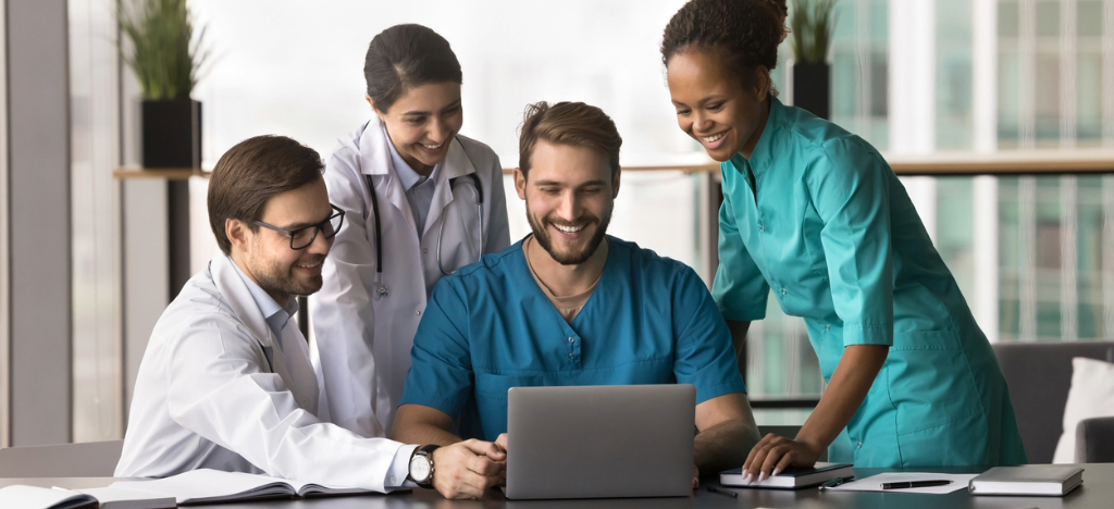 Medical billing software systems - A team of medical professionals accessing their medical billing software using a laptop.